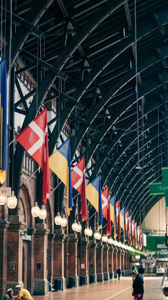 danish and ukrainian flags at arrival hall of a central station in copenhagen